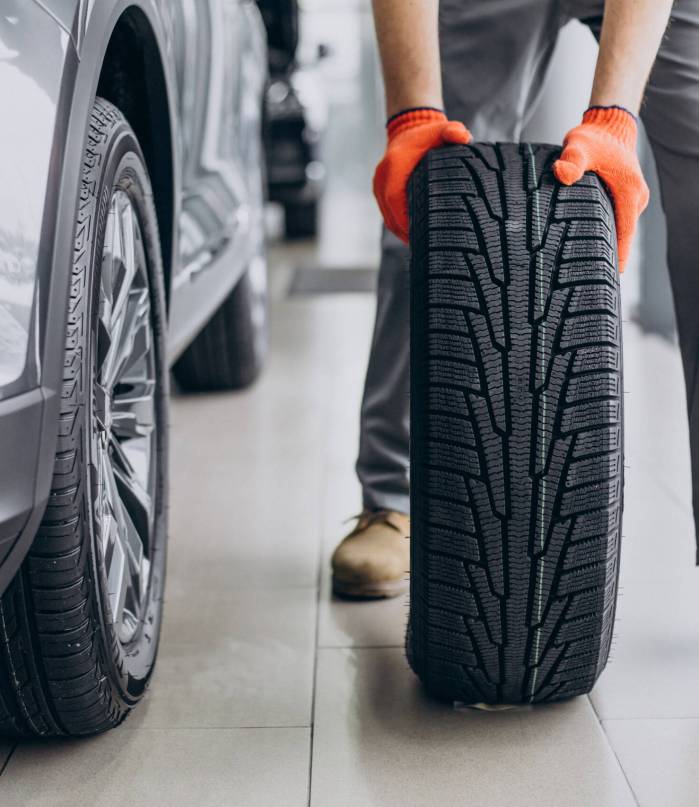 Mechanic changing tires in a car service